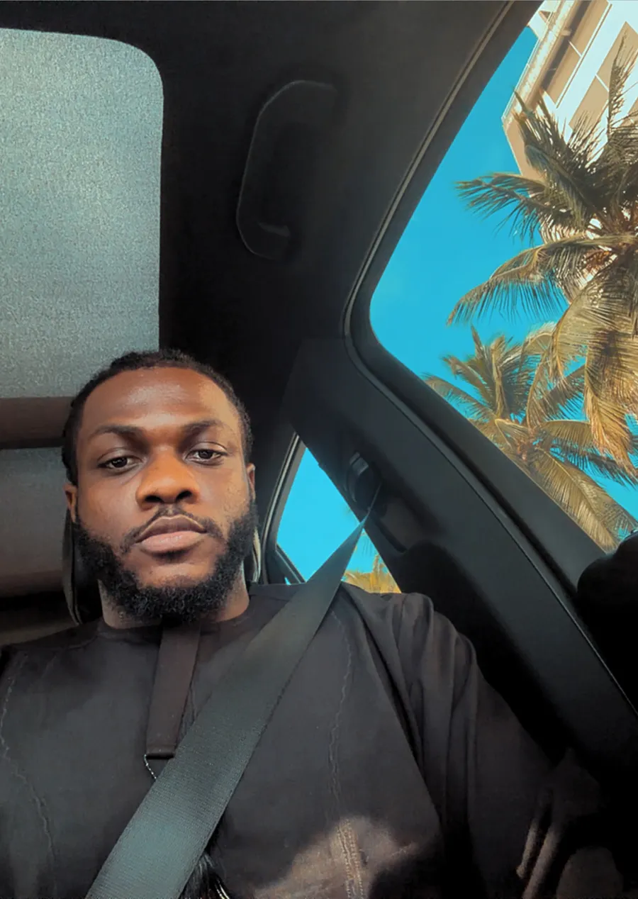 Codefred in a car on a sunny day, palm trees through the window